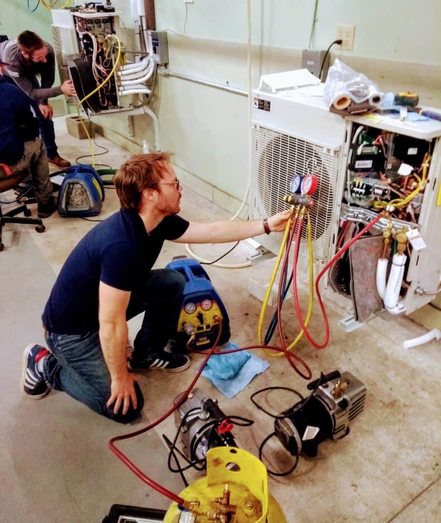 Professional heat pump cleaning team with specialized equipment for PTAC unit service Nova Scotia